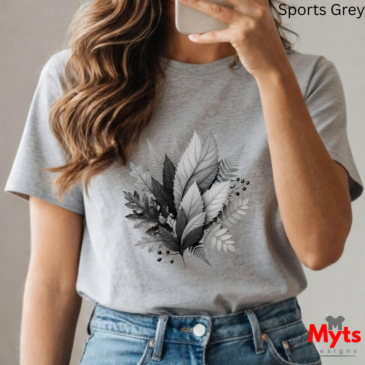 Person wearing a gray t-shirt with leaf design, taking a selfie.