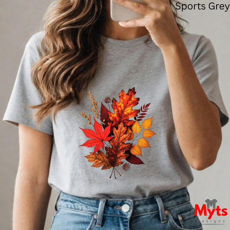 Person wearing a gray t-shirt with autumn leaf design, taking a selfie.