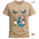 A Sand colored graphic T-shirt featuring three colourful seahorses, blue butterflies, tropical flowers, starfish and seashells in a vibrant ocean wildlife design.