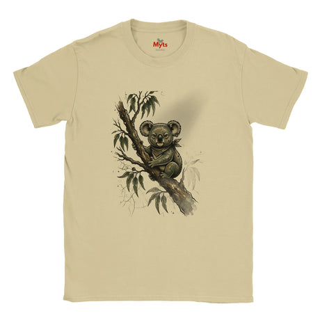 A Sand crewneck t-shirt featuring a detailed graphic print of a koala sitting on a tree branch with eucalyptus leaves. The shirt is displayed flat against a clean white background, with the red 'Myts' brand logo visible inside the collar.