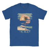Front view of vintage beach T-shirt featuring palm trees and retro sunset graphic onheather royal cotton tee