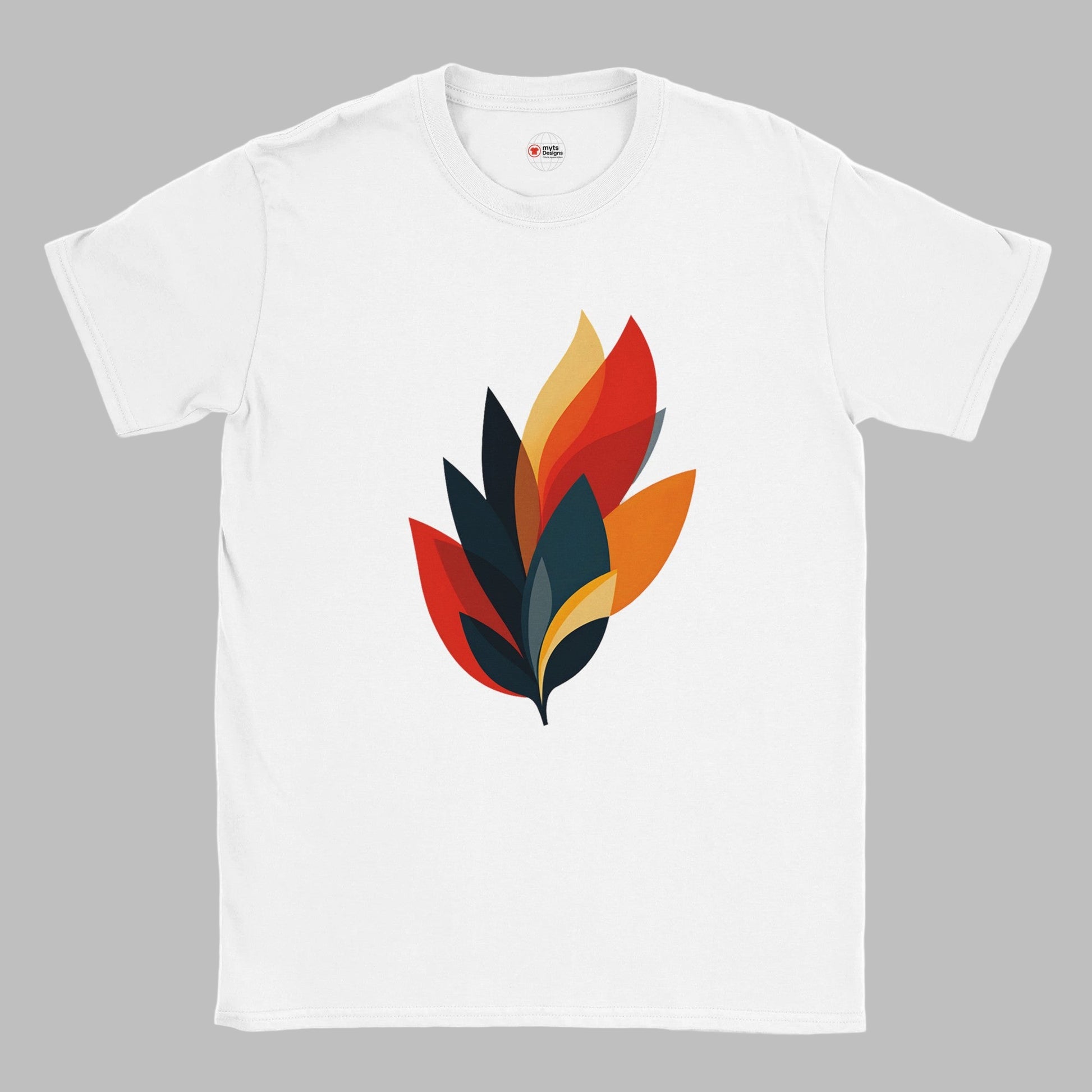 A white cotton T-shirt with a modern abstract autumn leaf design in layered shades of orange, red, yellow, and dark teal, styled on a wooden surface with a straw hat and denim jeans. The shirt features the MytsDesigns logo.