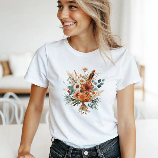 A woman wearing a white t-shirt with a floral design in a bright room.