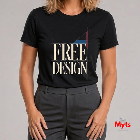 A woman wearing a black short-sleeve graphic T-shirt with the words 'FREE IN DESIGN' in large cream lettering and dark gray trousers, photographed against a light gray studio background. A small 'Myts' logo appears in the bottom right corner.