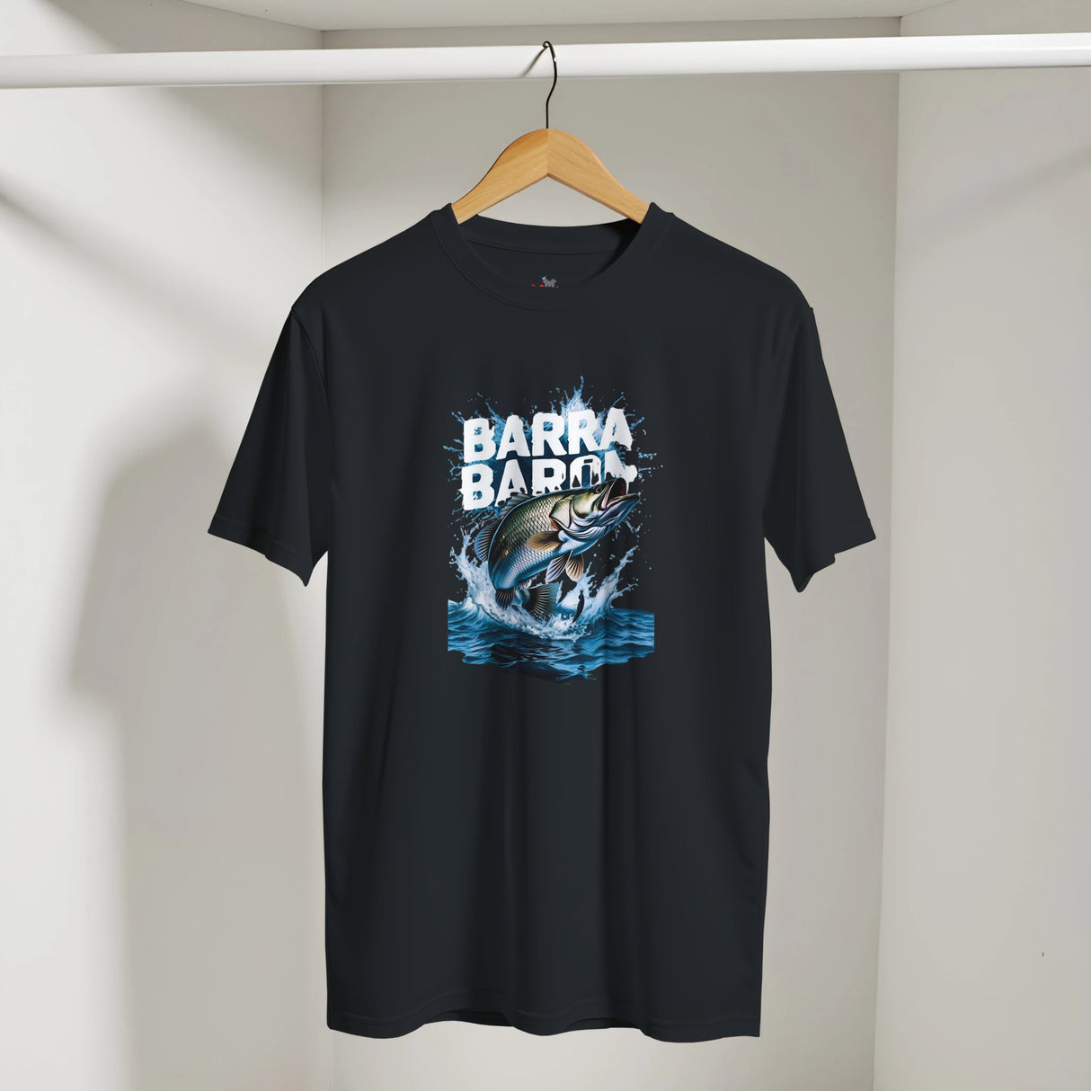 Black t-shirt with a fish graphic and 'Barra Barra' text on a hanger against a white wall.