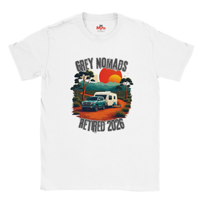 A white short-sleeve crewneck t-shirt featuring a retro-style graphic print of a grey pickup truck and a white camper van on an orange dirt road, with the text 'GREY NOMADS RETIRED 2026' and a sunset background.