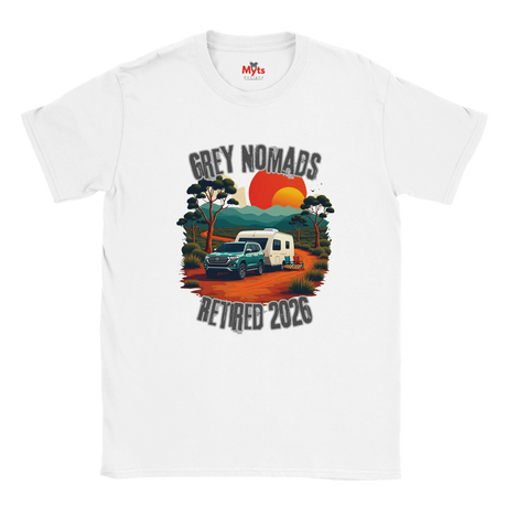 A white short-sleeve crewneck t-shirt featuring a retro-style graphic print of a grey pickup truck and a white camper van on an orange dirt road, with the text 'GREY NOMADS RETIRED 2026' and a sunset background.