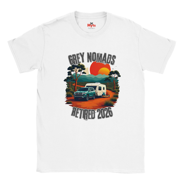 A white short-sleeve crewneck t-shirt featuring a retro-style graphic print of a grey pickup truck and a white camper van on an orange dirt road, with the text 'GREY NOMADS RETIRED 2026' and a sunset background.