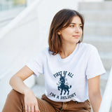 A woman wearing a white t-shirt with a 'Cute Donkey Design' design, sitting on the steps.