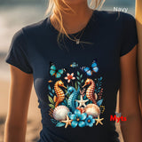 A woman wearing a black t-shirt with seahorses and butterflies, blurred beach background