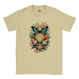 A Sand crewneck T-shirt featuring a colorful graphic print of a butterfly, seashells, starfish, and coral on the front, with the brand name 'The Myts' printed inside the collar.