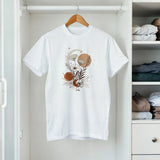 White t-shirt with floral design on a hanger in a closet
