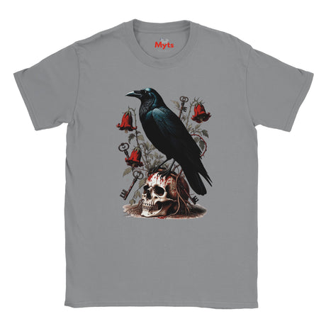A gray crewneck t-shirt featuring a gothic-style graphic print of a black raven perched on a skull, surrounded by red bells, keys, and roses. The brand name 'Mits' is printed in red on the inside neck label.