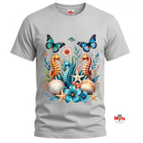 A graphic T-shirt featuring three colourful seahorses, blue butterflies, tropical flowers, starfish and seashells in a vibrant ocean wildlife design.