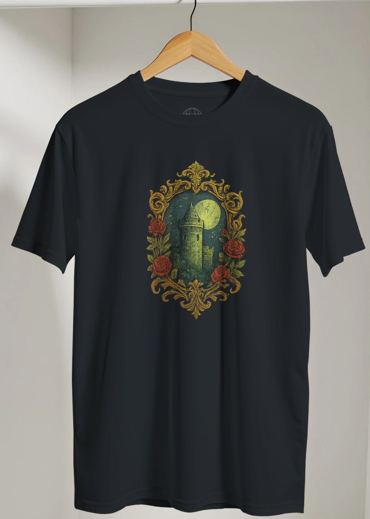 Black t-shirt with a decorative design on a hanger against a plain background