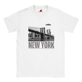 White soft casual tee showing the New York City skyline with a stylized spaceship graphic soaring above, printed on ultra-soft Gildan 64000 cotton.