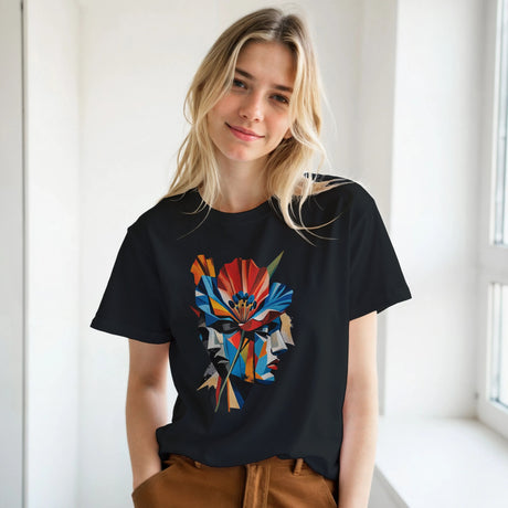 Woman wearing a black abstract two face poppy T-shirt featuring colourful geometric portrait artwork in red, blue, yellow, black and cream.