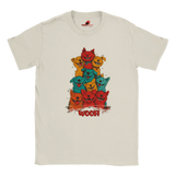 A flat lay white T-shirt featuring a vibrant graphic of cartoon puppies stacked in red, orange, blue, and yellow hues, with the playful text “WOOF!” below the design.