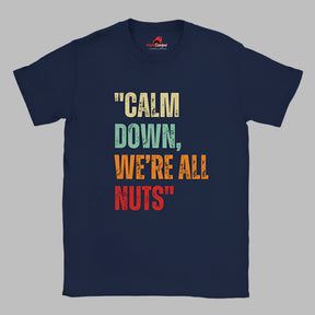 A Flat lay view of a navy colored retro-style casual tee featuring bold distressed vintage typography reading “Relax — We’re All Weird Here,” printed on ultra-soft Gildan 64000 cotton.


