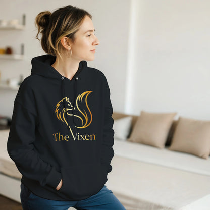 Person wearing a black hoodie with Gold fox vixen design in a room.
