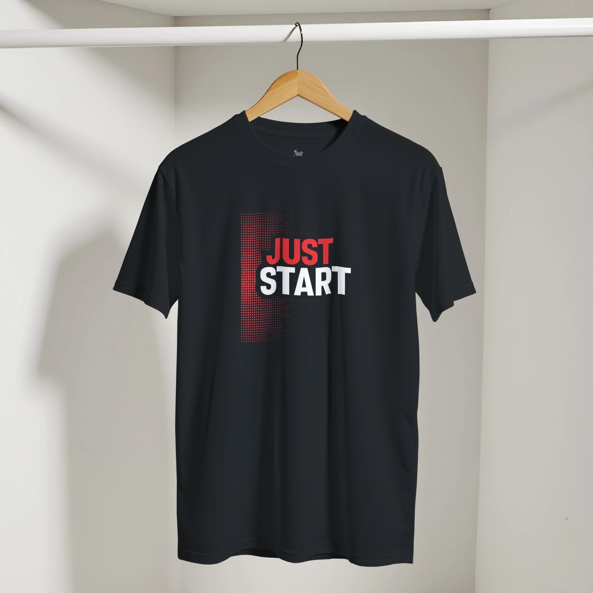 Black t-shirt with 'JUST START' text on a hanger against a neutral background