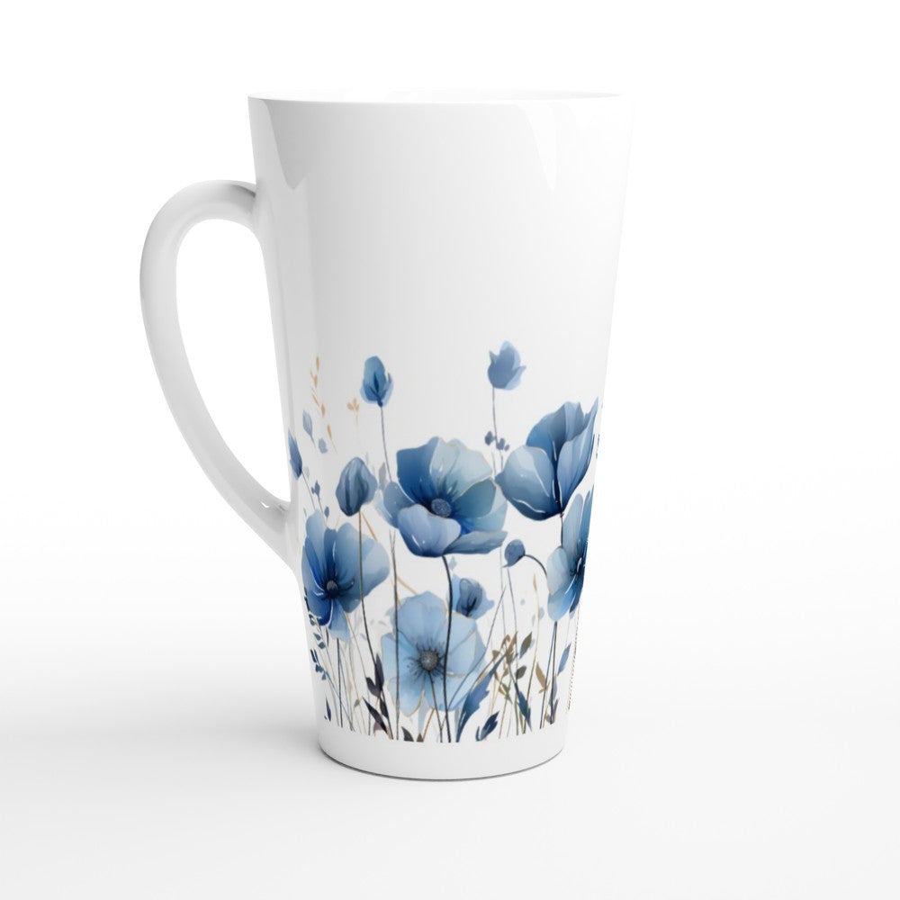 A tall white ceramic latte mug with a handle, decorated with a watercolor-style pattern of blue poppy flowers and green stems near the bottom, shown on a white background.