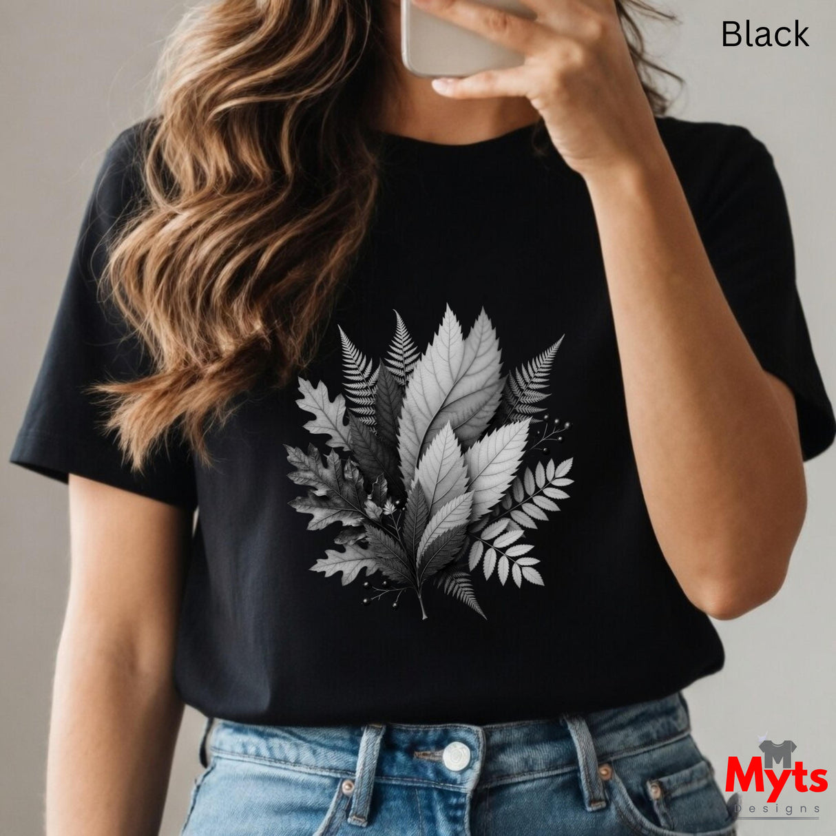 Person wearing a black t-shirt with leaf design, taking a selfie.