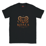 A black short-sleeve crewneck t-shirt featuring a graphic print of a koala face with a crescent moon and leaf motif, above the text 'KOALA' and 'MY TREE, MY HOME' in orange.