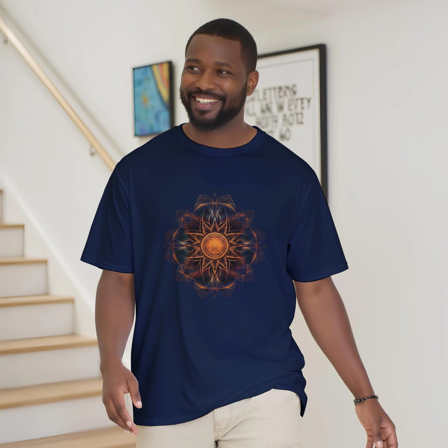 Man wearing a navy blue t-shirt with a sunflower design in a home setting
