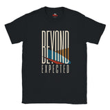A navy blue short-sleeve t-shirt with a graphic print on the front reading 'BEYOND EXPECTED' in white, featuring a stylized surfboard design in cream, orange, teal, and red.