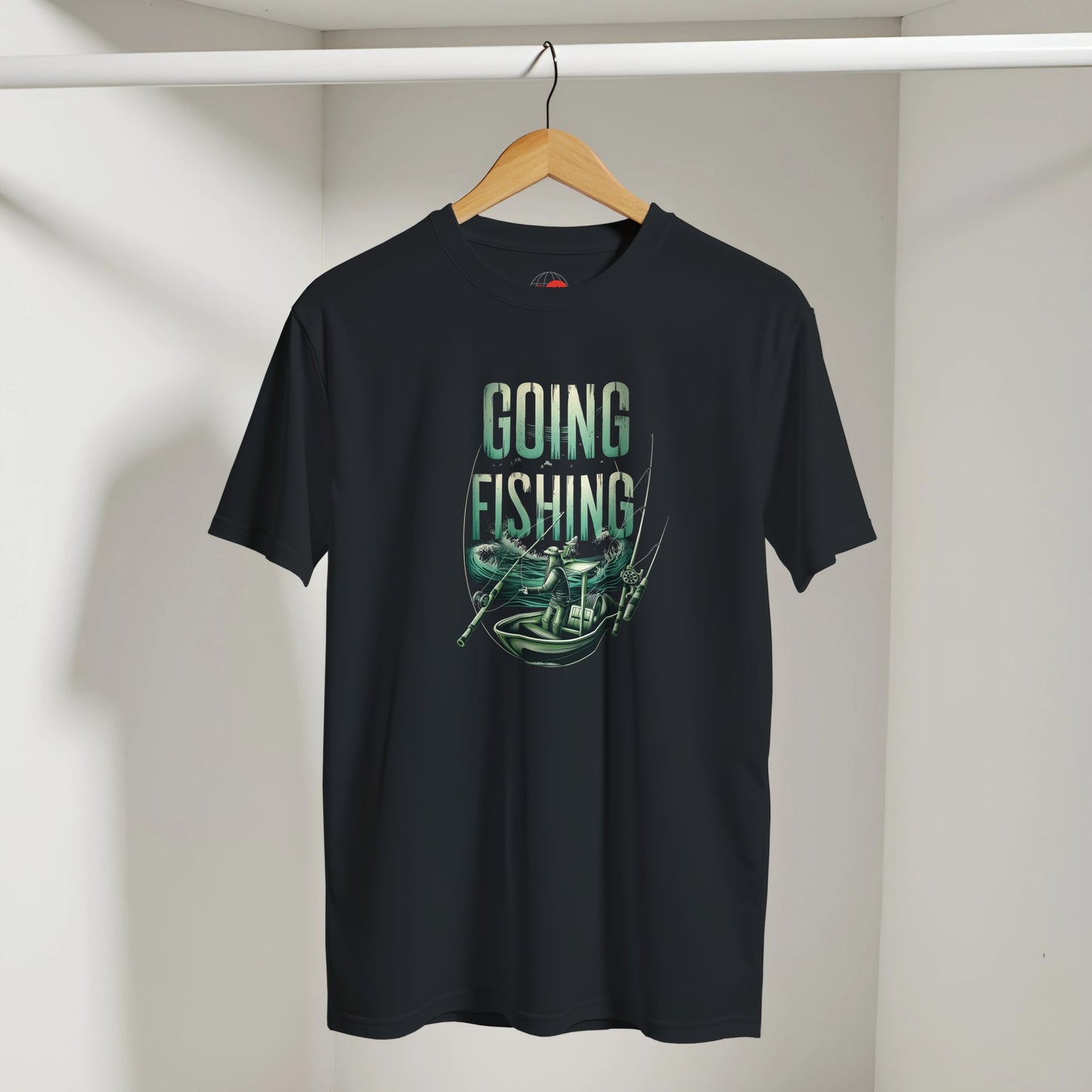 Black t-shirt with 'Going Fishing' graphic on a hanger against a white wall