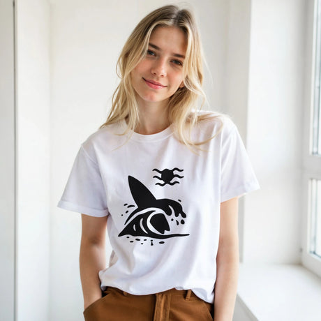Woman wearing a white t-shirt with a black graphic design, standing indoors.