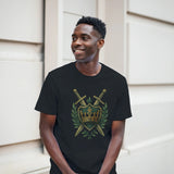 Man wearing a black t-shirt with a gold and green emblem design, standing against a light-colored wall.
