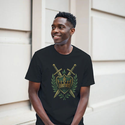 Man wearing a black t-shirt with a gold and green emblem design, standing against a light-colored wall.