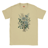 A beige short-sleeve crewneck t-shirt featuring a central graphic print of a floral bouquet with blue-gray flowers and green leaves, displayed on a clean white background.