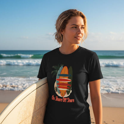Person wearing a black t-shirt with a graphic design on a beach