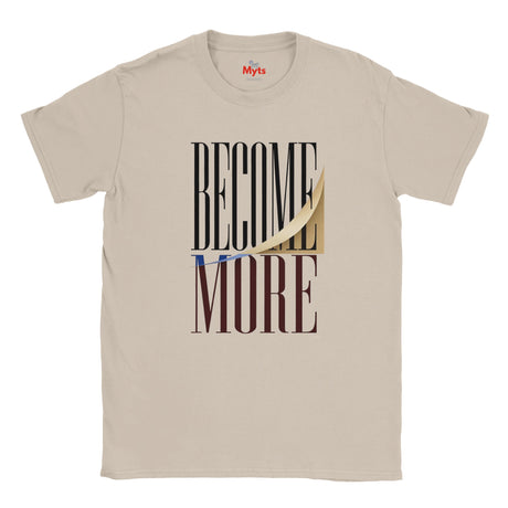 A natural crewneck t-shirt with a graphic print on the front reading 'BECOME MORE' in black and dark brown block letters, featuring a gold peel-off sticker effect and a small blue accent line. The brand name 'Myts' is printed inside the collar.