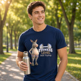 Smiling man outdoors wearing a Navy funny fitness donkey T-shirt while holding a metal water bottle.