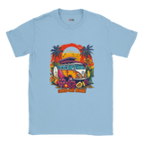 A light blue T-shirt with a vibrant graphic of a retro yellow Kombi van, surfboards, tropical flowers, palm trees, and a bold orange sunset.