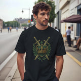 Man wearing a black T-shirt with an embroidered-style design of a green shield featuring a gold crown, flanked by crossed swords and laurel leaves—regal, medieval-inspired graphic centered on the chest.
