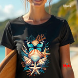 A woman wearing a black short-sleeve t-shirt with a colorful graphic of seashells, starfish, and a butterfly. The background is a blurred beach scene with the word 'Black' in the top-right corner.