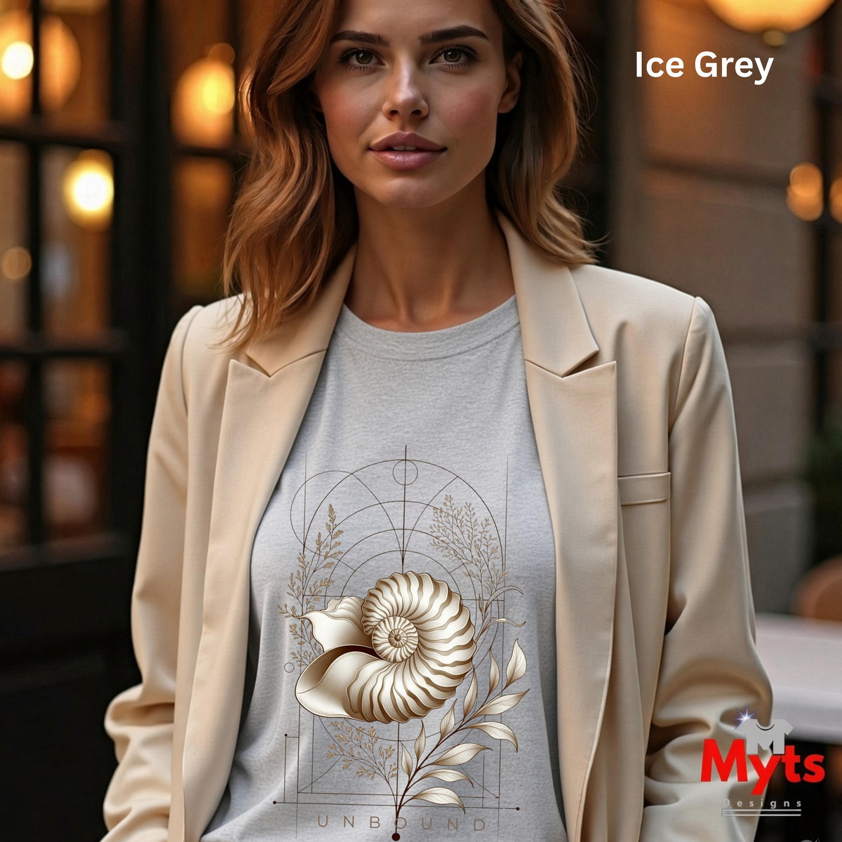 “Woman wearing an Ice Grey Unbound Nautilus shell graphic T-shirt beneath a beige blazer.”