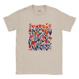 Sand unisex T‑shirt featuring a minimalist poppy design in vibrant reds, pinks, and greens—with clean lines and botanical elegance—against a white background. Soft cotton tee shown flat for clarity.