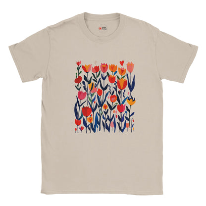 Sand unisex T‑shirt featuring a minimalist poppy design in vibrant reds, pinks, and greens—with clean lines and botanical elegance—against a white background. Soft cotton tee shown flat for clarity.