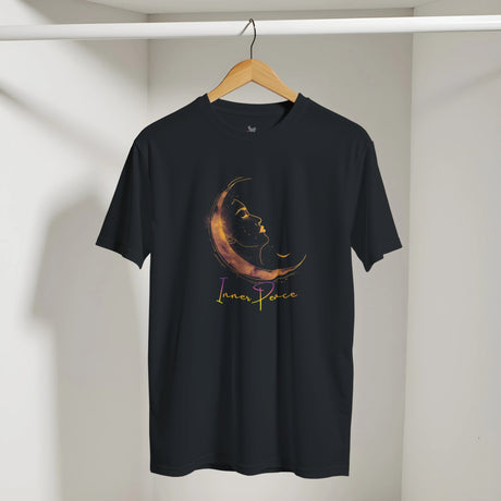 Black t-shirt with a moon and star design and 'Inner Peace' text on a hanger against a white wall.