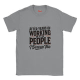 A icd gray short-sleeve crewneck t-shirt with a graphic text print reading 'AFTER YEARS OF WORKING WITH PEOPLE I DESERVE THIS' in black and white, with thin red accent lines, shown on a plain white background.