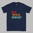 Navy Retro-style casual tee featuring bold distressed vintage typography reading “Relax — We’re All Weird Here,” printed on ultra-soft Gildan 64000 cotton.

