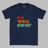 Navy Retro-style casual tee featuring bold distressed vintage typography reading “Relax — We’re All Weird Here,” printed on ultra-soft Gildan 64000 cotton.

