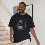 A man wearing a black t-shirt with a colorful raven design indoors.