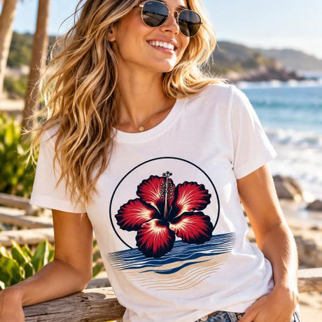White tropical hibiscus flower graphic T-shirt featuring a vibrant red bloom, navy circular outline and stylised blue and sandy-gold ocean waves.